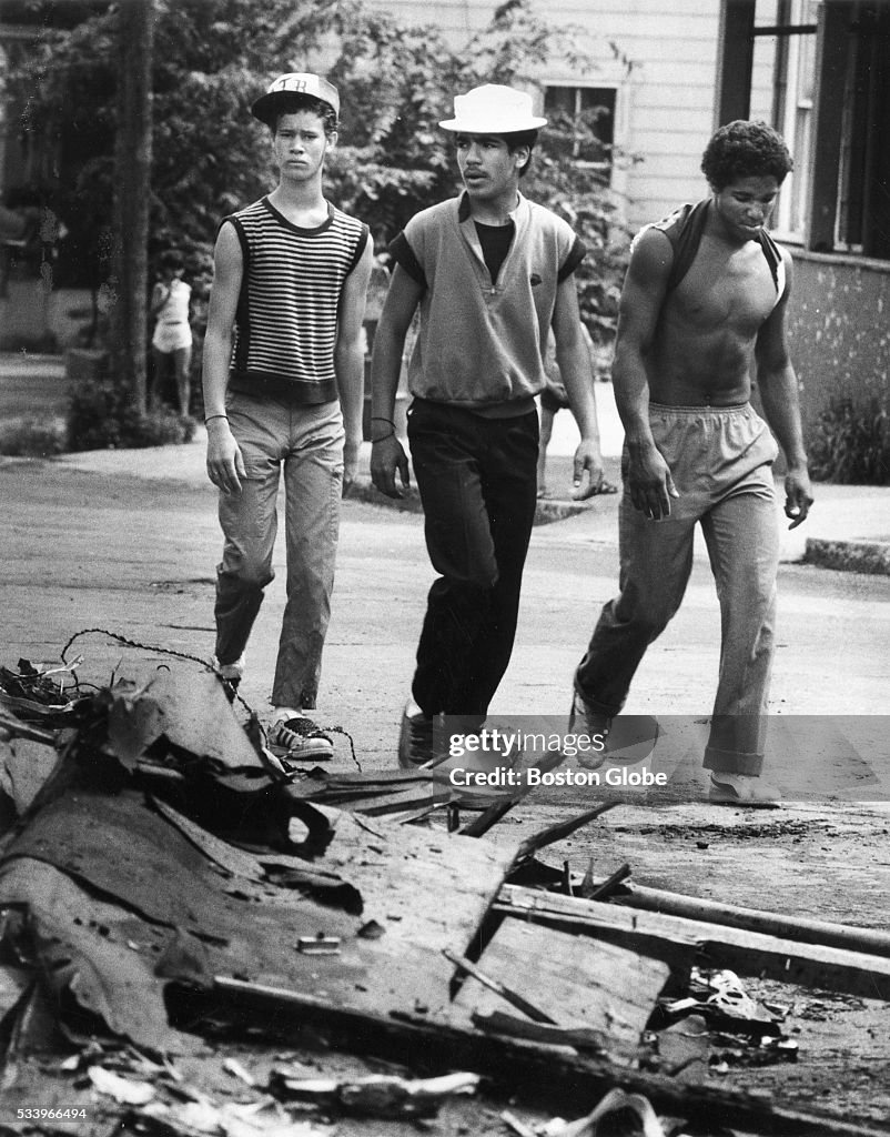 Lawrence Riots Youths walk past the debris of a liquor store on Oxford Street, Aug ...
