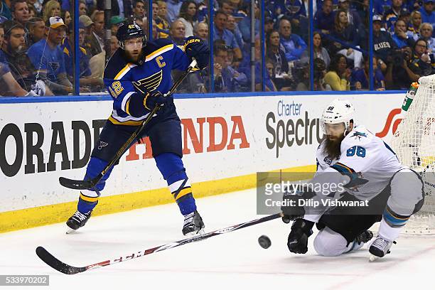 David Backes of the St. Louis Blues passes the puck against Brent Burns of the San Jose Sharks during the third period in Game Five of the Western...