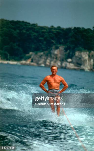 American film star Kirk Douglas water-skiing at the Eden Roc annex to the Hotel du Cap d'Antibes on the French Riviera, August 1969.