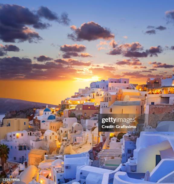 santorini sunset over the village of oia in greece - oia santorini bildbanksfoton och bilder