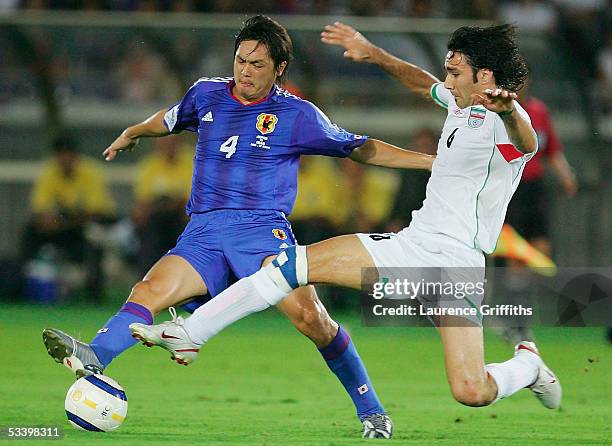 Yasuhito Endo of Japan battles with Javed Nekounam of Iran during The 2006 Fifa World Cup Asian Qualifiers match between Japan and Iran at The...