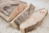 Sliced Halibut fish on ice.