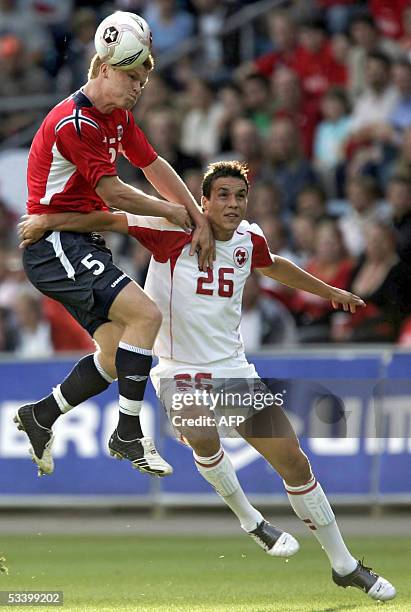 Norway's John Arne Riise vies with Switzerland's Philipp Degen during the friendly football Norway vs Switzerland at the Ullevaal Stadium in Oslo, 17...