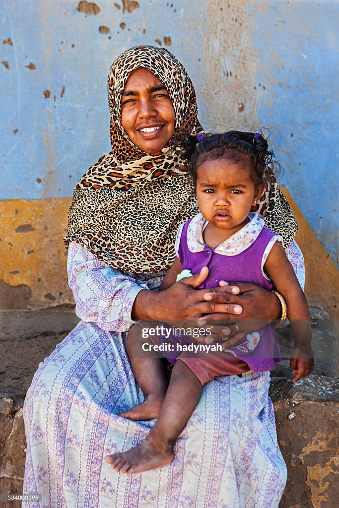 Muslim woman holding her baby, Southern Egypt, Africa