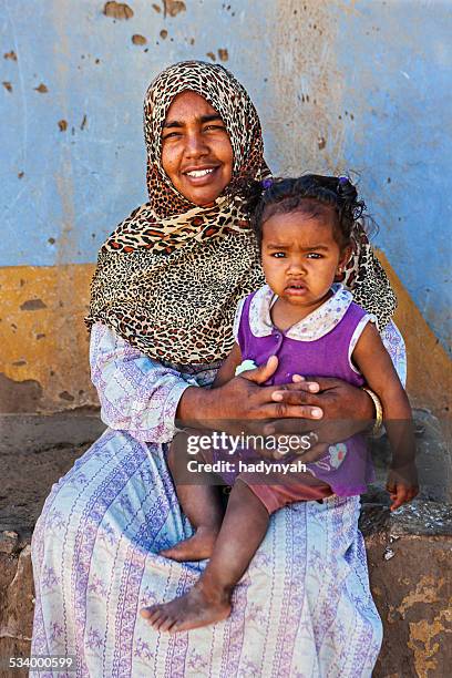 muslim woman holding her baby, southern egypt, africa - egyptian family stock pictures, royalty-free photos & images