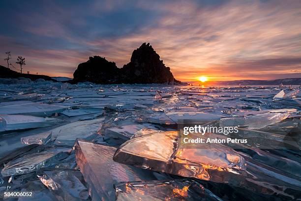 sunset at the rock shamanka. lake baikal, winter - lake baikal stock pictures, royalty-free photos & images