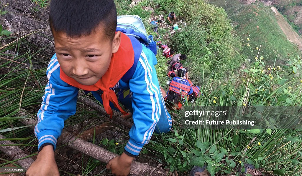 Children From Remote Chinese Village Climb Unsecured Vine Ladders On A Vertical Cliff