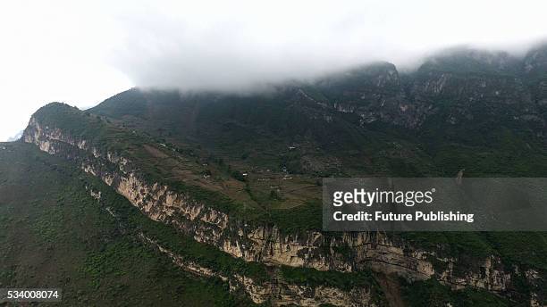 View of the farm land and houses of Atule'er Village on the slope on top of a mountain in Zhaojue county in southwest China's Sichuan province on May...