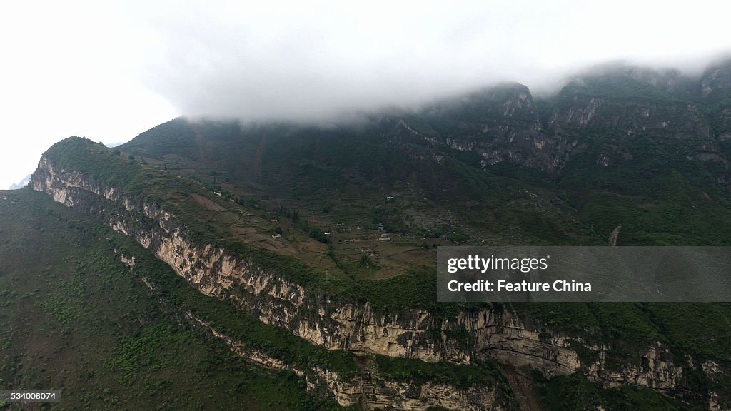 Children From Remote Chinese Village Climb Unsecured Vine Ladders On A Vertical Cliff