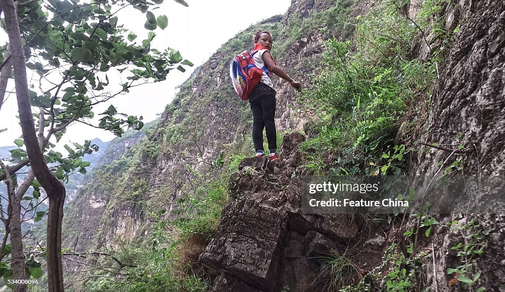 Children From Remote Chinese Village Climb Unsecured Vine Ladders On A Vertical Cliff