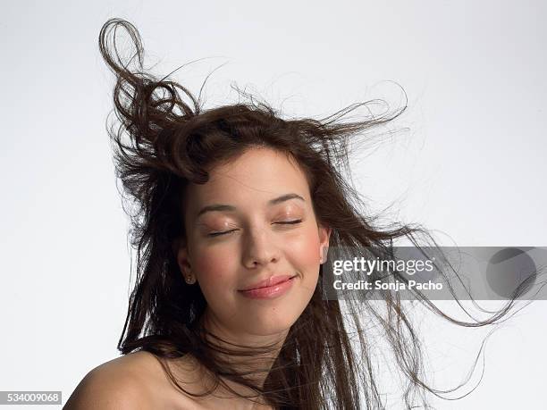 young woman with closed eyes - hair wind stock pictures, royalty-free photos & images