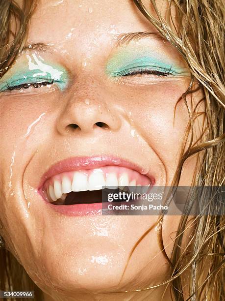 young woman with water running over her face - wet face stock pictures, royalty-free photos & images