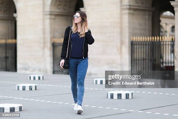 Nathalie Van den Berg , is wearing a Frnch blue top, a Zara black bomber jacket, Senso white shoes, a Love Moschino black bag, and Dior sunglasses,...