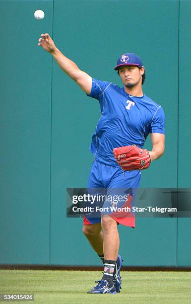 Texas Rangers starting pitcher Yu Darvish fielding balls during batting practice as the Los Angeles Angels visit Globe Life Park in Arlington, Texas,...