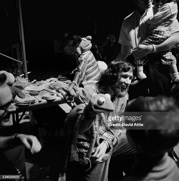Puppeteer Jim Henson holding Kermit, amuses children during rehearsal for an episode of Sesame Street at Reeves TeleTape Studio in 1970 in New York...