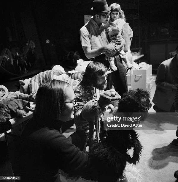 Puppeteers Jim Henson holding Kermit and Frank Oz with Grover amuse children during rehearsal for an episode of Sesame Street at Reeves TeleTape...