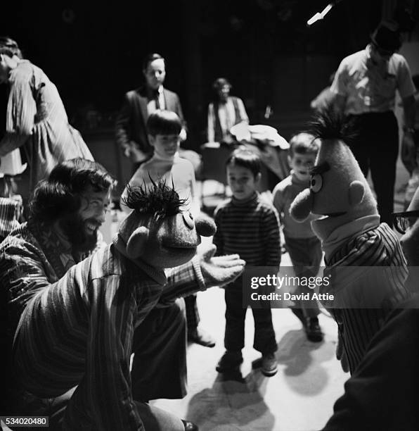 Puppeteers Jim Henson holding Ernie and Frank Oz with Bert, rehearse for an episode of Sesame Street at Reeves TeleTape Studio in 1970 in New York...