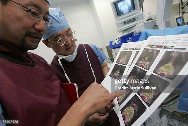 Dr. Katsuto Shinohara and Dr. I-Chow Hsu review images of a prostate with cancer before performing a bracytherapy operation on a man with prostate...