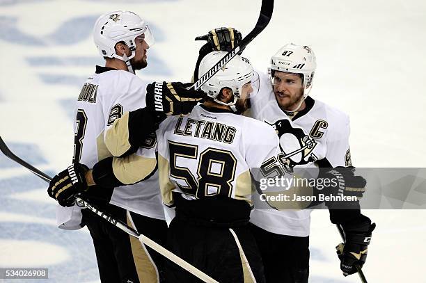 Kris Letang of the Pittsburgh Penguins celebrates with his teammates Sidney Crosby and Brian Dumoulin after scoring a goal against Andrei Vasilevskiy...