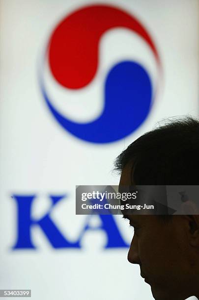 Pilot of Korean Air stands at the Korean Air's ticket and check-in desk at Gimpo Airport on August 18, 2005 in Seoul, South Korea. South Korea's...