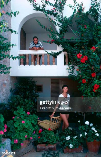 Greek shipowner George Vatis and his wife Helen surrounded by bougainvillea, hibiscus and geraniums on the Greek island of Hydra, 1978.