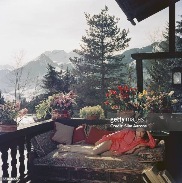 Mrs Alfredo Cernadas reclines on a balcony in Gstaad, 1977.