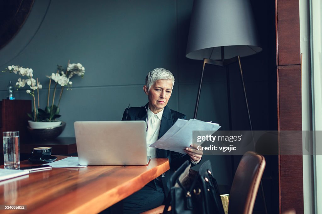 Mature Businesswoman Working In Her office.