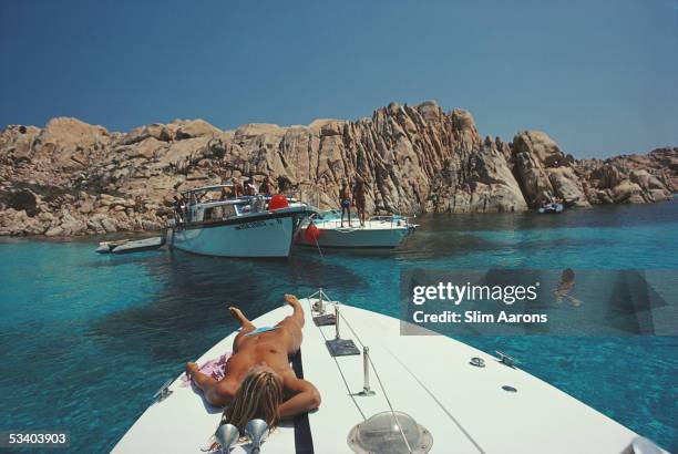 Countess Gioia Gaetani-Lovatelli relaxes on deck during a yachting holiday in Porto Rotondo, 1982.