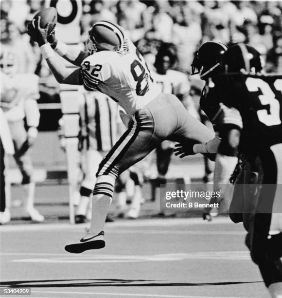 American professional football player Ozzie Newsome of the Cleveland Browns reaches to make a catch during a game, early 1980s.