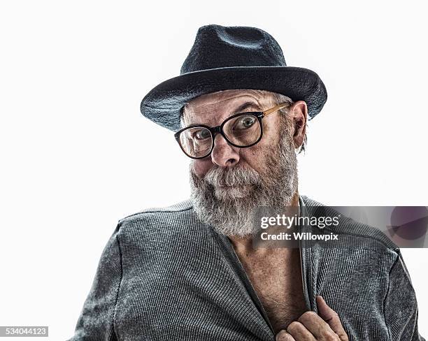 flirting senior man wearing black fedora hat - hairy old man stockfoto's en -beelden