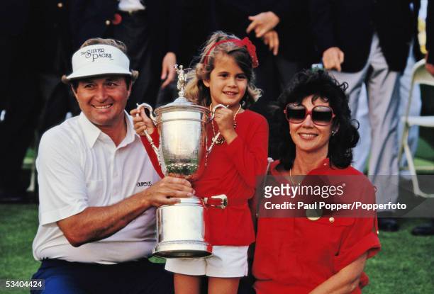 American professional golfer Raymond Floyd pictured holding the trophy with his daughter Christina Floyd and wife Maria Floyd after finishing in...