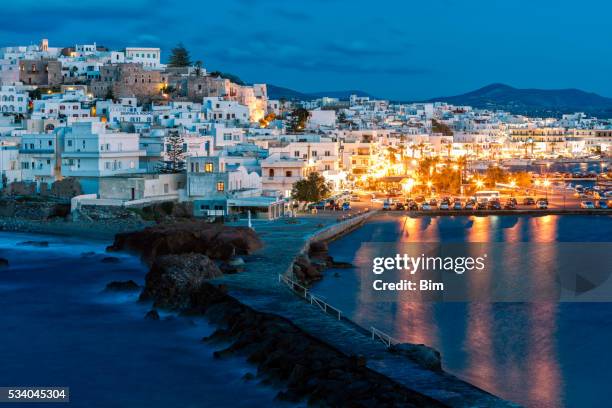 naxos illuminated at dusk, cyclades, greece - cyclades islands stock pictures, royalty-free photos & images