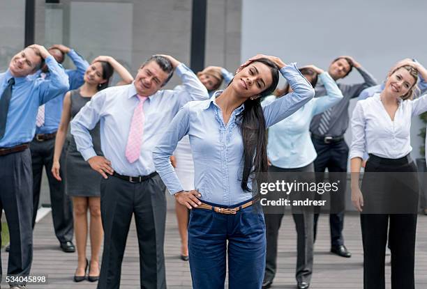 business people taking an active break - neck stretch stock pictures, royalty-free photos & images