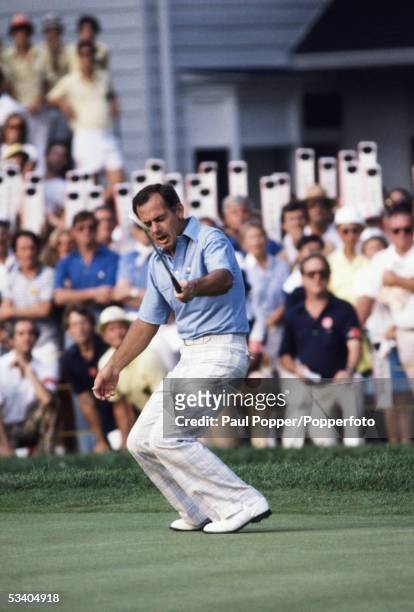 Australian professional golfer David Graham bends down in celebration after sinking his final putt on the 72nd hole to win the 1981 US Open by three...