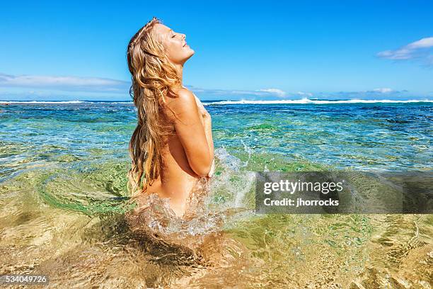 bathing beauty au naturel - women skinny dipping stockfoto's en -beelden