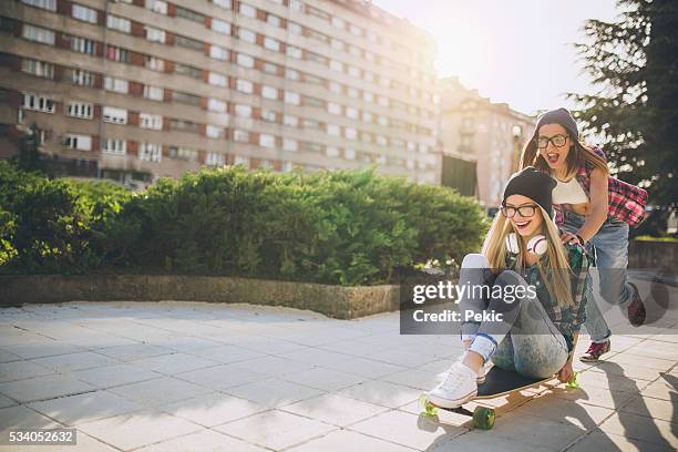 besties having fun on longboard in city - city to surf stock pictures, royalty-free photos & images