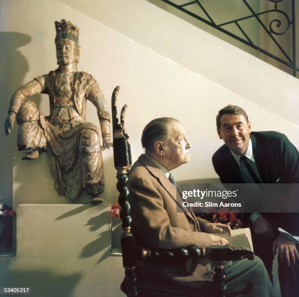 American photographer Slim Aarons peeks into his own shot of British author Somerset Maugham at Cap Ferrat, France, 1963.