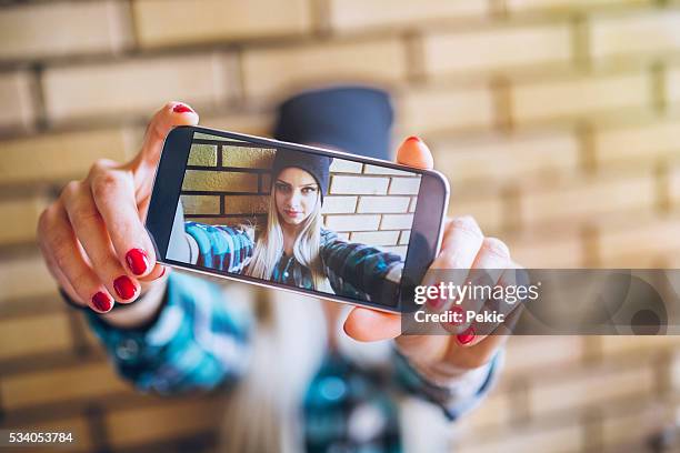 emo girl taking selfie against brick wall - emo girl stock pictures, royalty-free photos & images