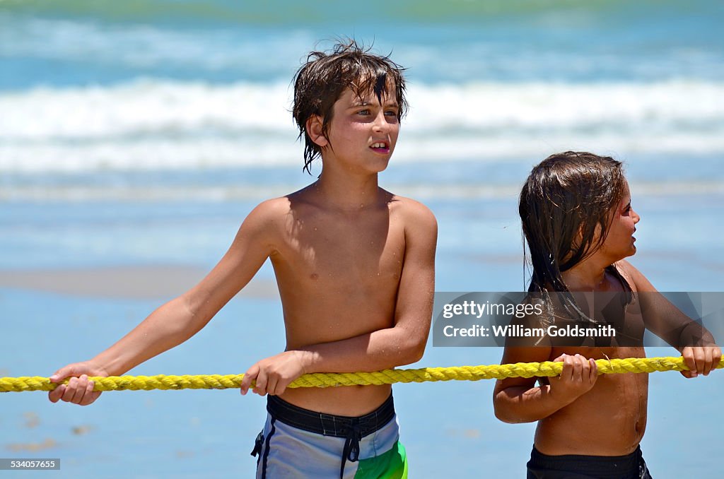 Two Boys at Beach Wait to Play Tug-of-War