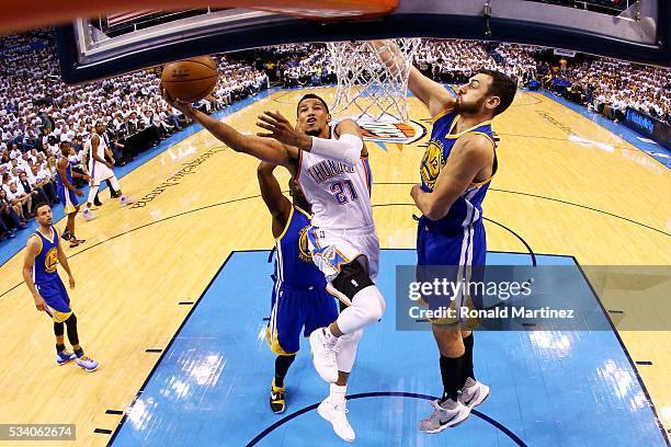 Andre Roberson of the Oklahoma City Thunder shoots against Andrew Bogut of the Golden State Warriors in the first half in game four of the Western...