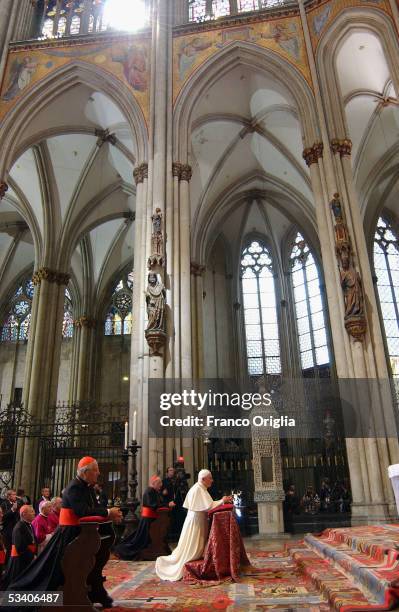 Pope Benedict XVI prays at Cologne Cathedral on August 18, 2005 in Cologne, Germany.. Pope Benedict XVI is in his native Germany for a four-day visit...