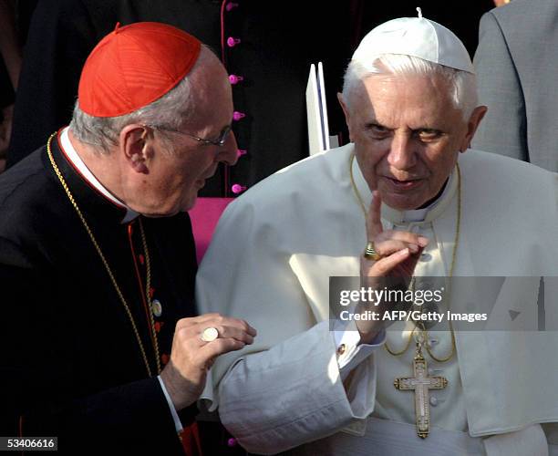 Pope Benedict XVI talks to Cologne's Archbishop Joachim Meisner outside Cologne's Cathedral, Germany, 18 August 2005, on the first of his...