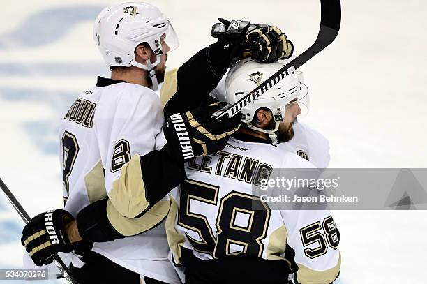 Kris Letang of the Pittsburgh Penguins celebrates with his teammates Sidney Crosby after scoring a goal against Andrei Vasilevskiy of the Tampa Bay...