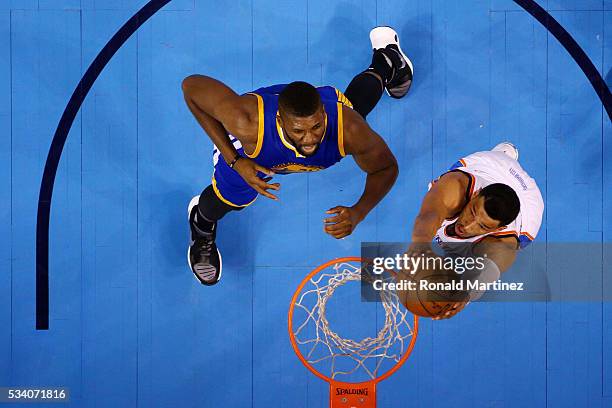 Andre Roberson of the Oklahoma City Thunder shoots against Festus Ezeli of the Golden State Warriors in the first half in game four of the Western...