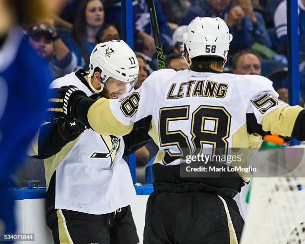 Bryan Rust of the Pittsburgh Penguins celebrates his goal with teammate Kris Letang against the Tampa Bay Lightning during the third period of Game...