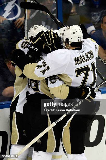 Bryan Rust of the Pittsburgh Penguins celebrates with his teammates after scoring a goal on Andrei Vasilevskiy of the Tampa Bay Lightning during the...