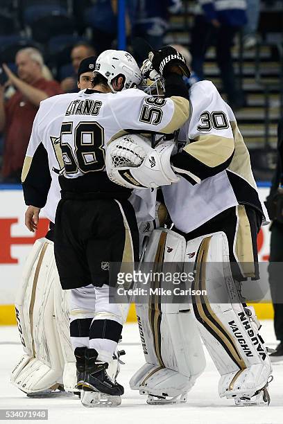 Matt Murray of the Pittsburgh Penguins celebrates with his teammates Kris Letang and Marc-Andre Fleury after defeating the Tampa Bay Lightning in...