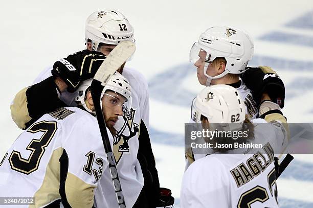 Nick Bonino of the Pittsburgh Penguins celebrates with his teammates after scoring an open net goal against the Tampa Bay Lightning during the third...