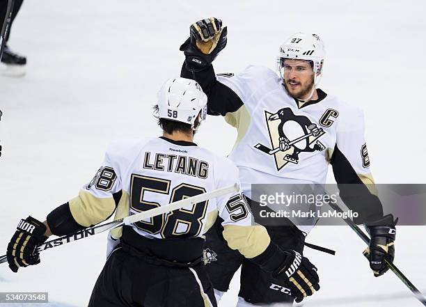 Kris Letang of the Pittsburgh Penguins celebrates his goal with teammate Sidney Crosby during the second period against the Tampa Bay Lightning...