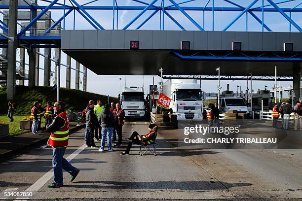 Unionists block the trucks' tollgate of the "Pont de Normandie", in Le Havre northwestern France, on May 25 to protest against the government's...